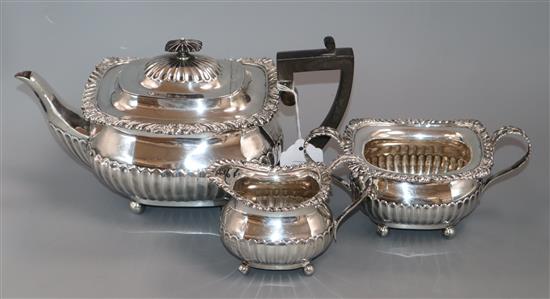 An Edwardian three-piece silver tea service of half-fluted gadrooned form, London 1906, William Hutton & Sons Ltd, approx 37oz